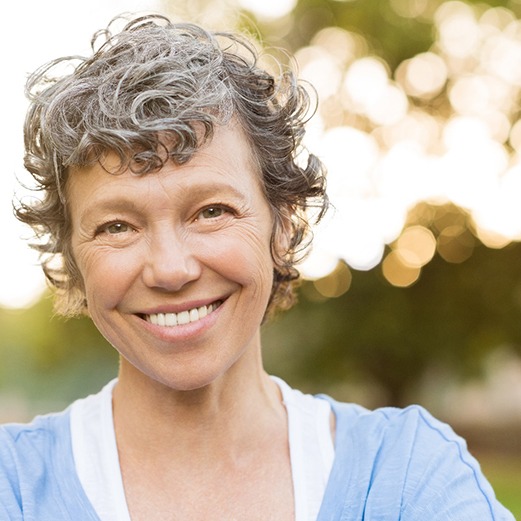 woman smiling while standing outside