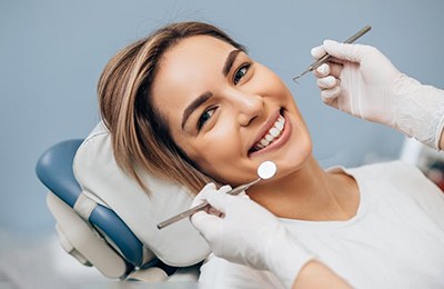 a patient smiling after undergoing dental implant treatment