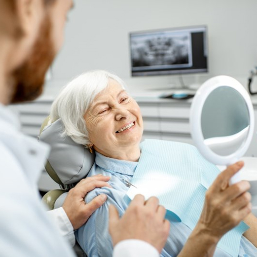 a patient smiling after getting dental implants