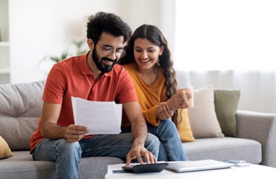 a couple calculating the cost of a payment plan