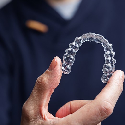 woman putting in Invisalign tray