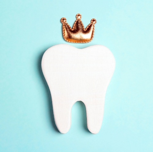 Animated tooth wearing gold royal crown