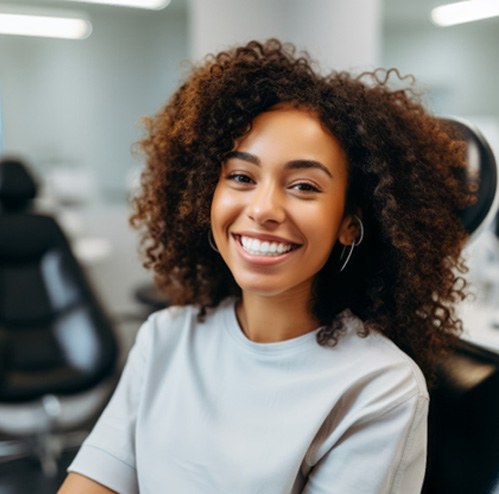 Smiling woman sitting in dental treatment chair