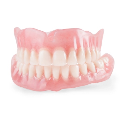 Set of full dentures against white background