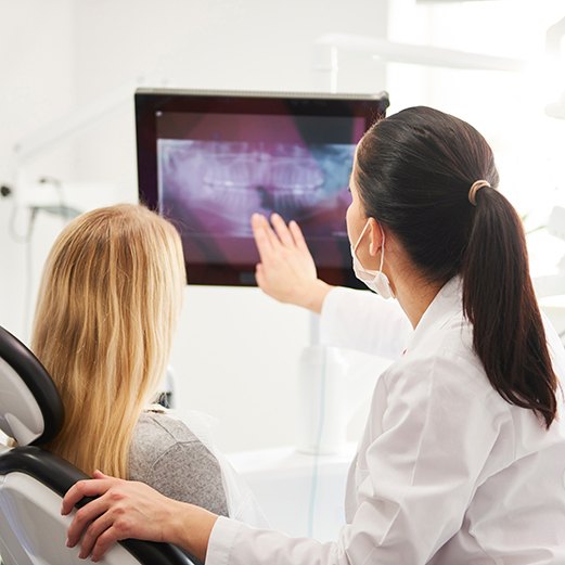 Dentist discussing failed dental implant with patient